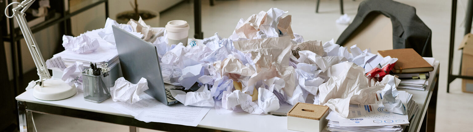 messy office desk with crumpled papers surrounding 2026 03 05 11 49 50 utc